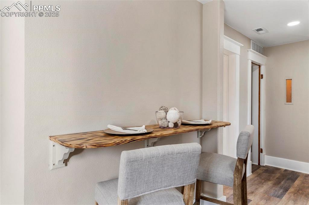Image 24 of 43: Dining area featuring wood finished floors and baseboards