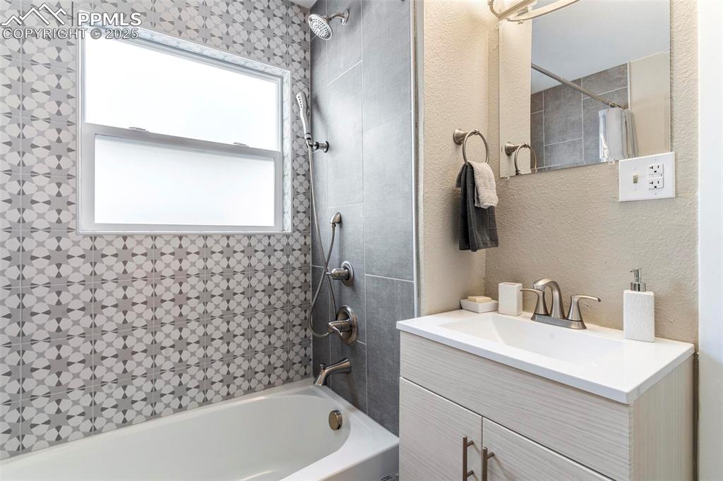Image 3 of 43: Bathroom with shower / tub combo and vanity