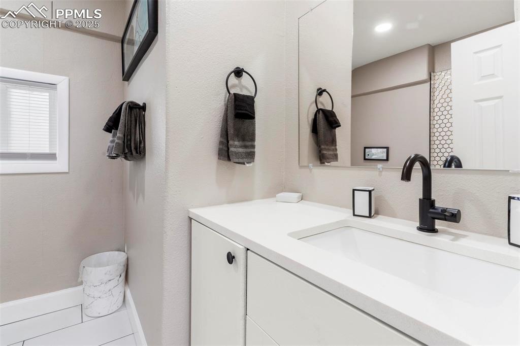 Image 34 of 43: Bathroom featuring vanity and baseboards