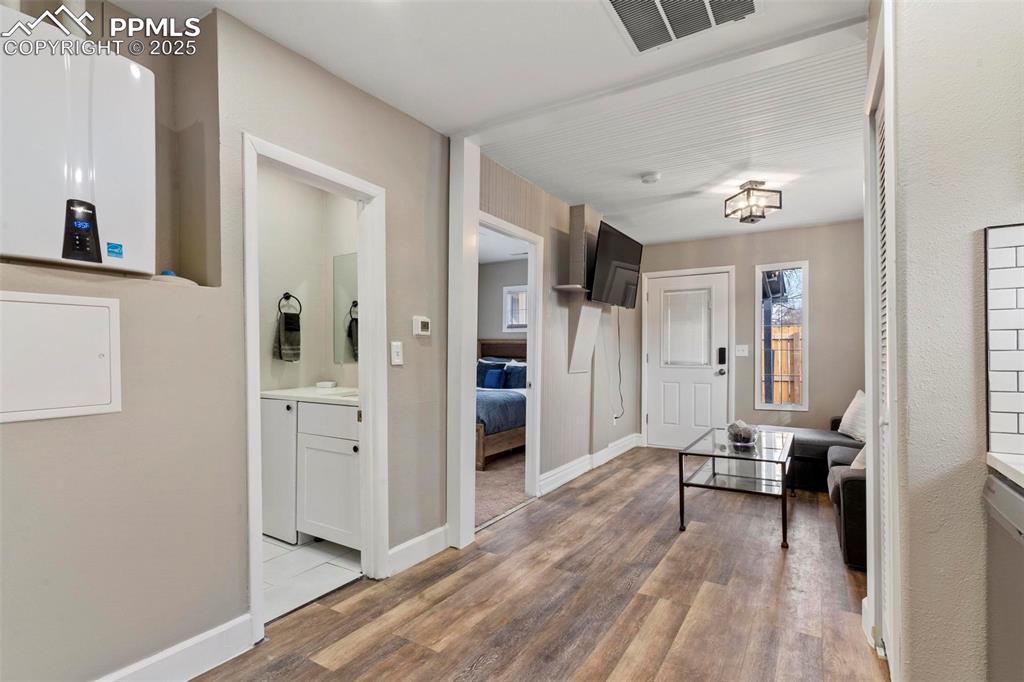 Image 39 of 43: Corridor featuring light wood finished floors and baseboards