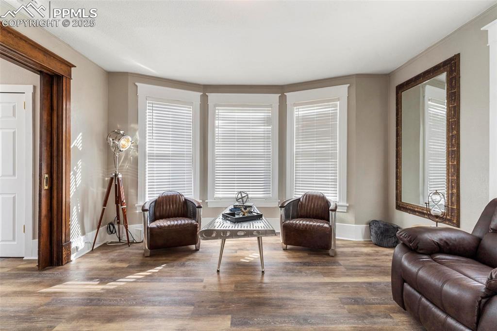 Image 7 of 43: Living area with wood finished floors and baseboards