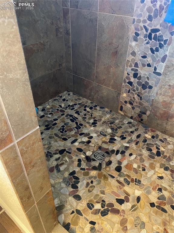 Image 13 of 25: Bathroom featuring a tile shower