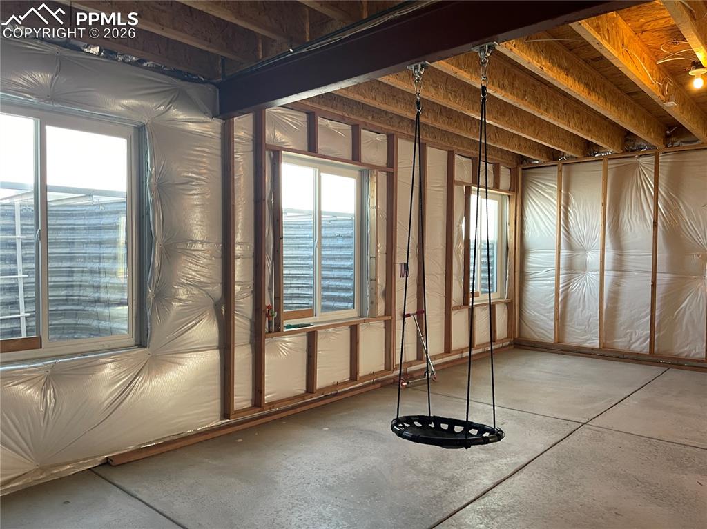 Image 19 of 25: Misc room with concrete flooring and plenty of natural light