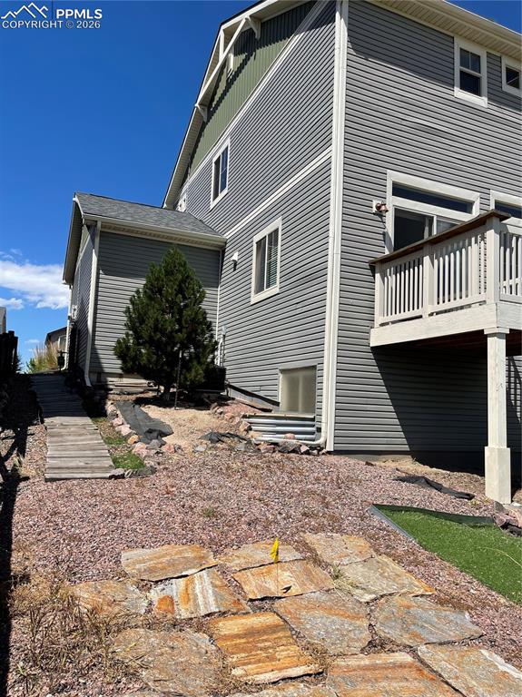 Image 21 of 25: Back of house featuring a wooden deck