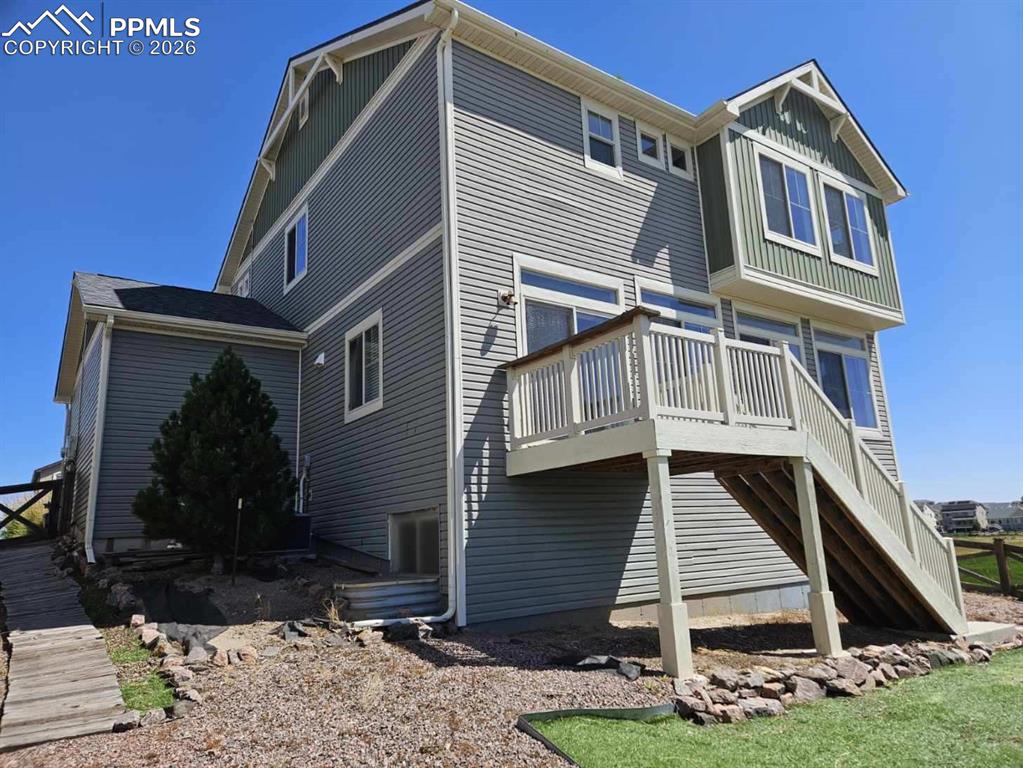 Image 22 of 25: Back of house with a deck and stairway