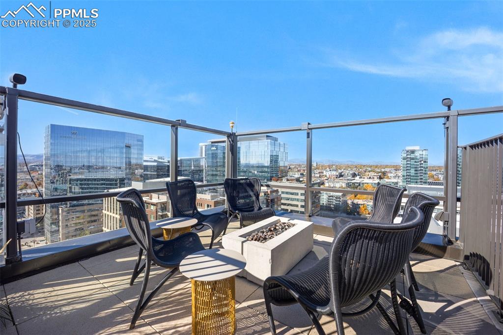Image 11 of 50: View of patio / terrace with a view of city and an outdoor fire pit