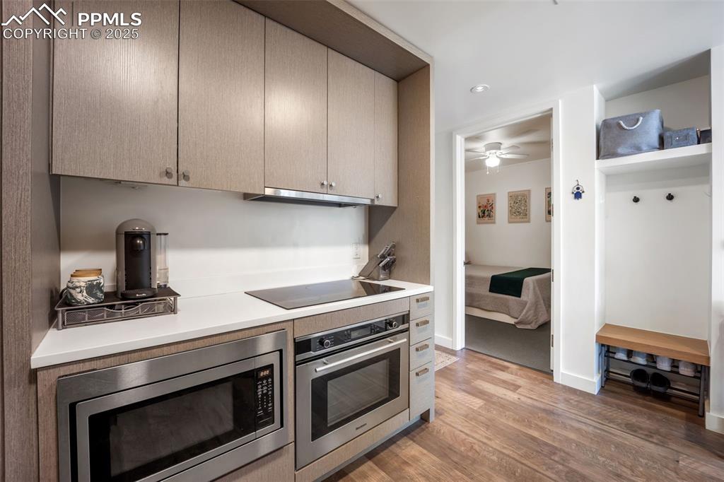 Image 28 of 50: Kitchen featuring appliances with stainless steel finishes, light counterto