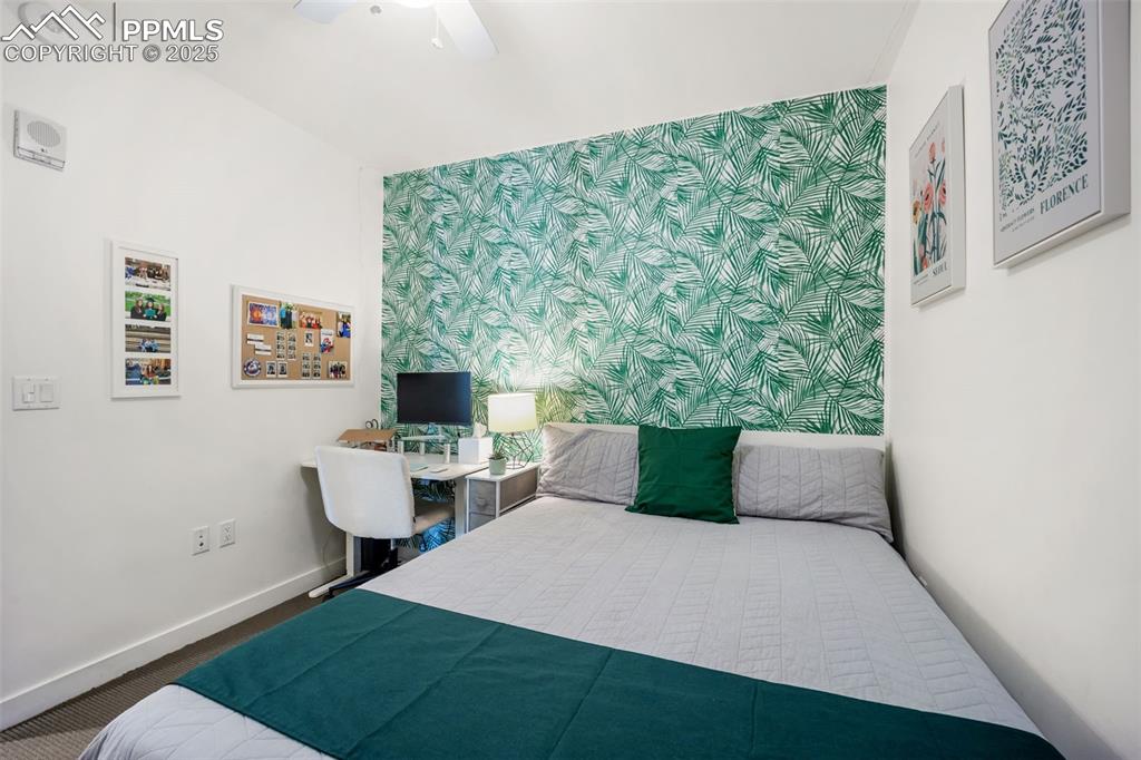 Image 31 of 50: Bedroom featuring a desk and ceiling fan