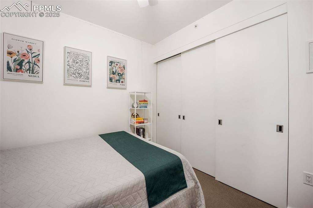 Image 32 of 50: Bedroom featuring carpet, a closet, and ceiling fan