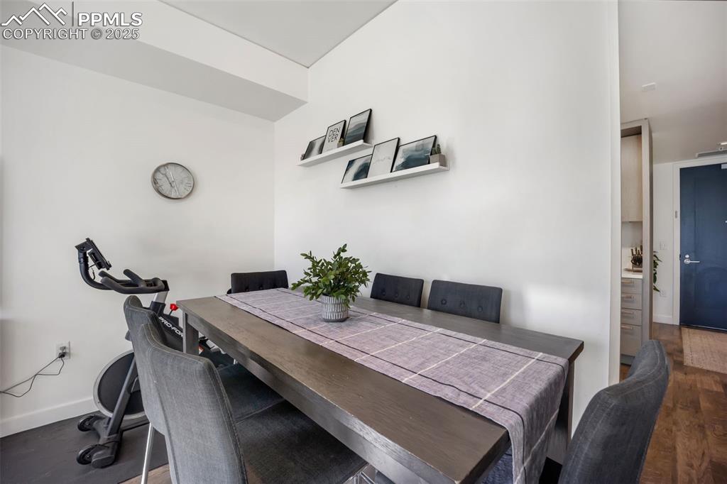 Image 33 of 50: Dining room with baseboards and dark wood finished floors