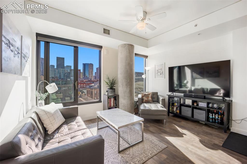 Image 34 of 50: Living area with wood finished floors and a ceiling fan