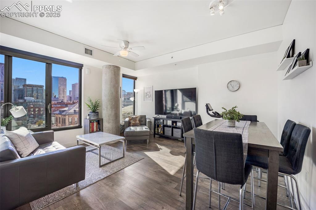 Image 37 of 50: Living area featuring ceiling fan and wood finished floors