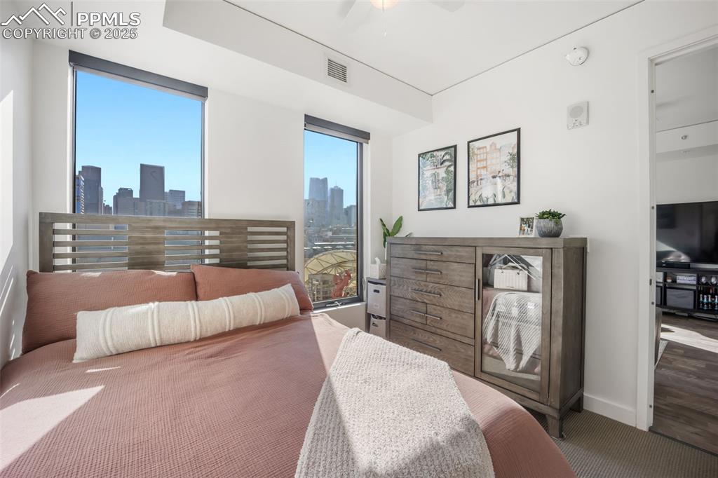 Image 40 of 50: Carpeted bedroom with ceiling fan and baseboards