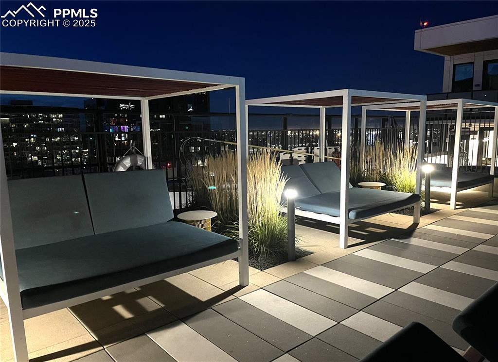 Image 48 of 50: Patio at twilight with a patio