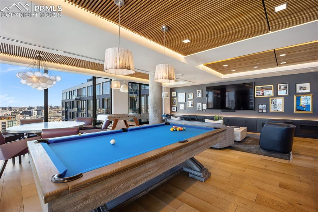 Image 5 of 50: Game room featuring billiards table, a wall of windows, wood ceiling, and a