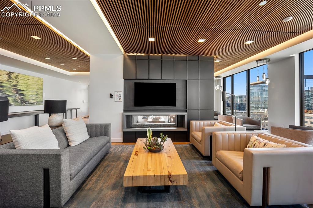 Image 7 of 50: 18th Floor Living room with wood ceiling, recessed lighting, and dark wood