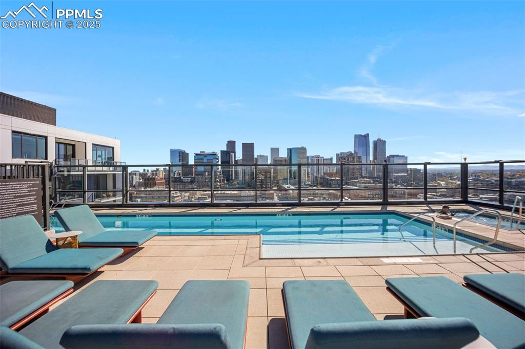 Image 8 of 50: Roof Top pool with a patio and a view of skyline