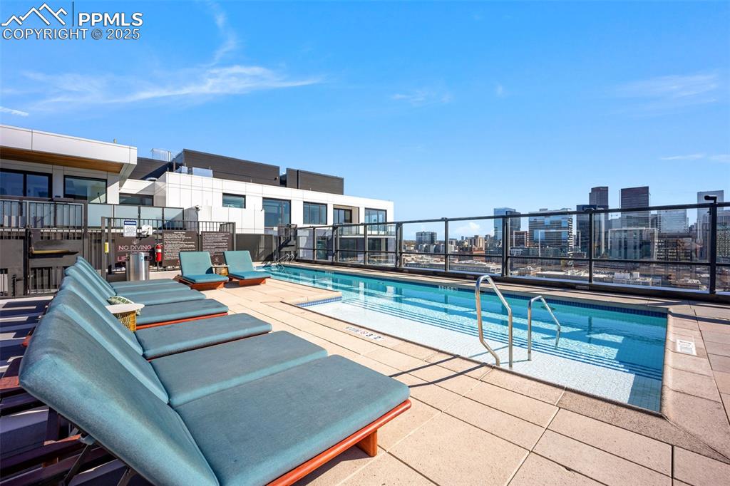 Image 9 of 50: Community jacuzzi pool with a view of city