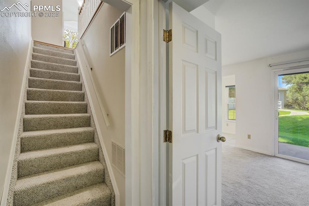 Image 27 of 41: Stairs down to fully finished basement.