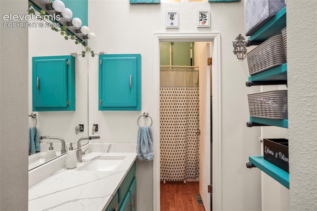Image 18 of 28: Bathroom featuring a white countertop with veining, rectangular integrated