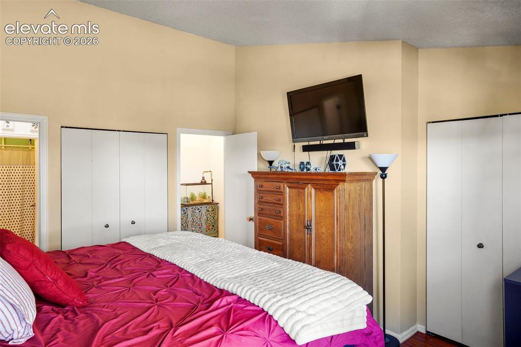 Image 21 of 28: Vaulted ceilings and dual white bi-fold closets