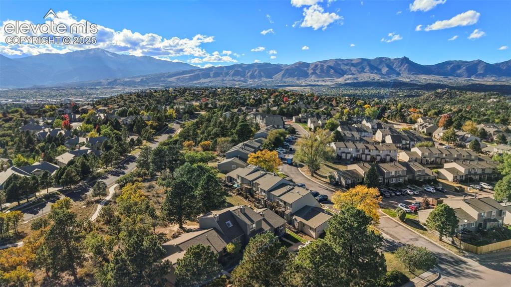 Image 26 of 28: Aerial perspective featuring mountainous terrain and expansive natural land