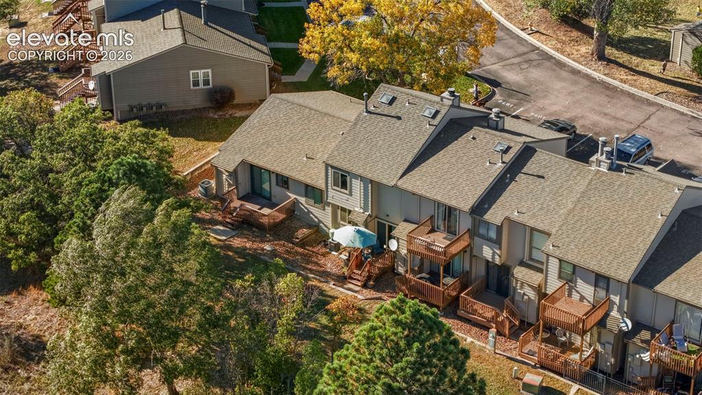 Image 27 of 28: Multi-level residential complex featuring shingled roofing, stacked wooden
