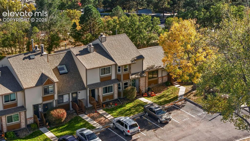 Image 28 of 28: Multi-level building with shingled roofing, lap siding, bay windows, and de