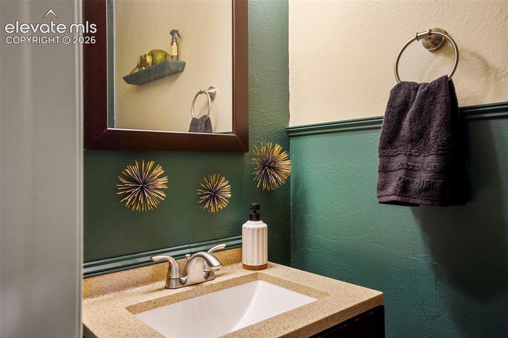 Image 7 of 28: Solid-surface vanity countertop with an integrated rectangular basin and du