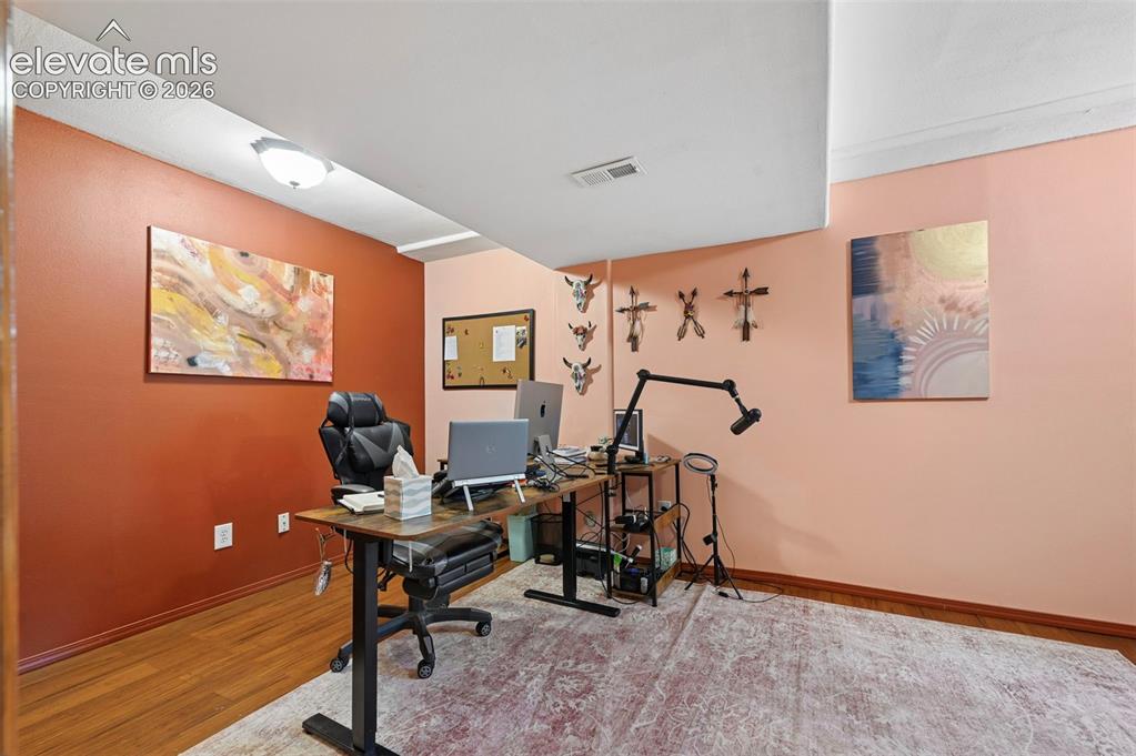 Image 15 of 34: Room featuring wood-finish flooring, recessed lighting, and a neutral color