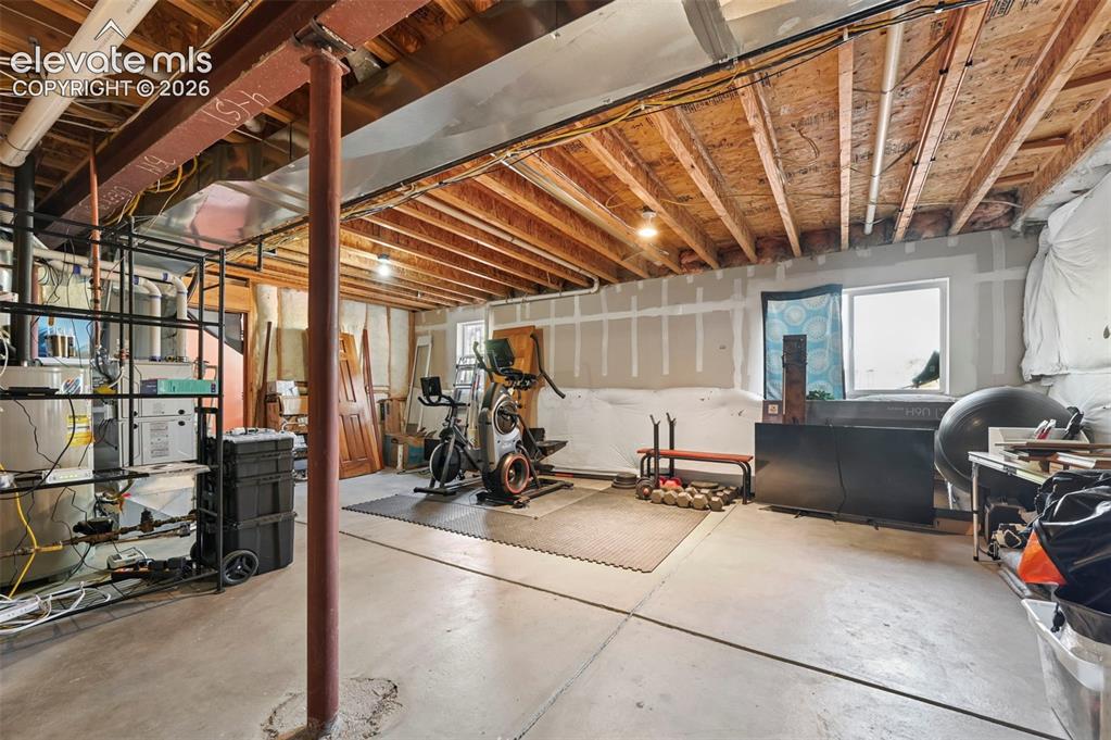 Image 17 of 34: Expansive unfinished basement featuring a concrete floor, exposed wood ceil
