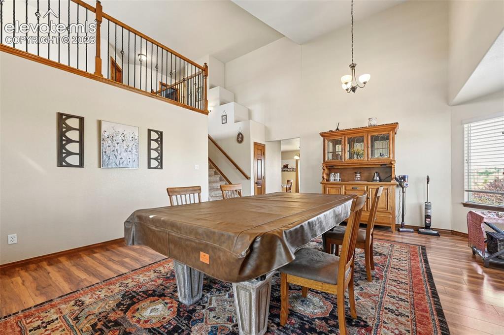 Image 25 of 34: Dining area featuring wood-finish flooring and a decorative area rug