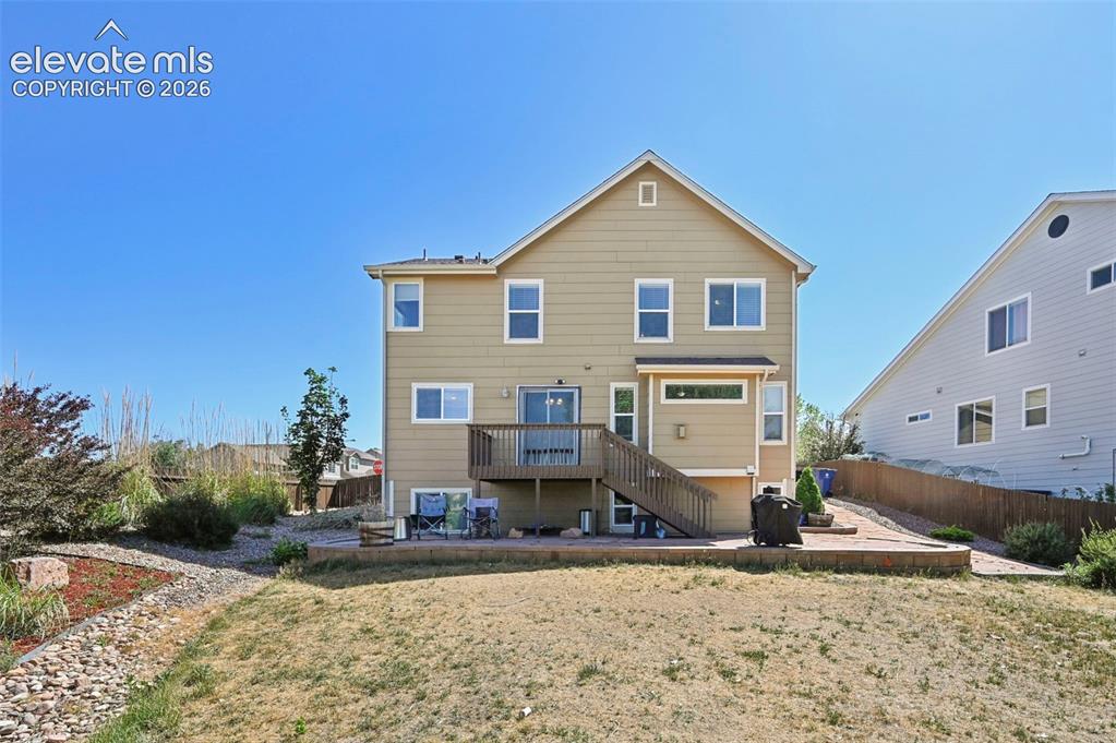 Image 29 of 34: Two-story residence featuring light tan siding with white trim