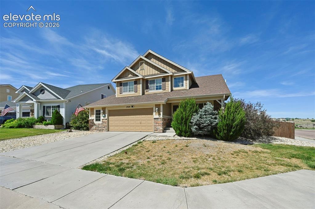 Image 30 of 34: Two-story residence featuring a combination of siding and stone veneer