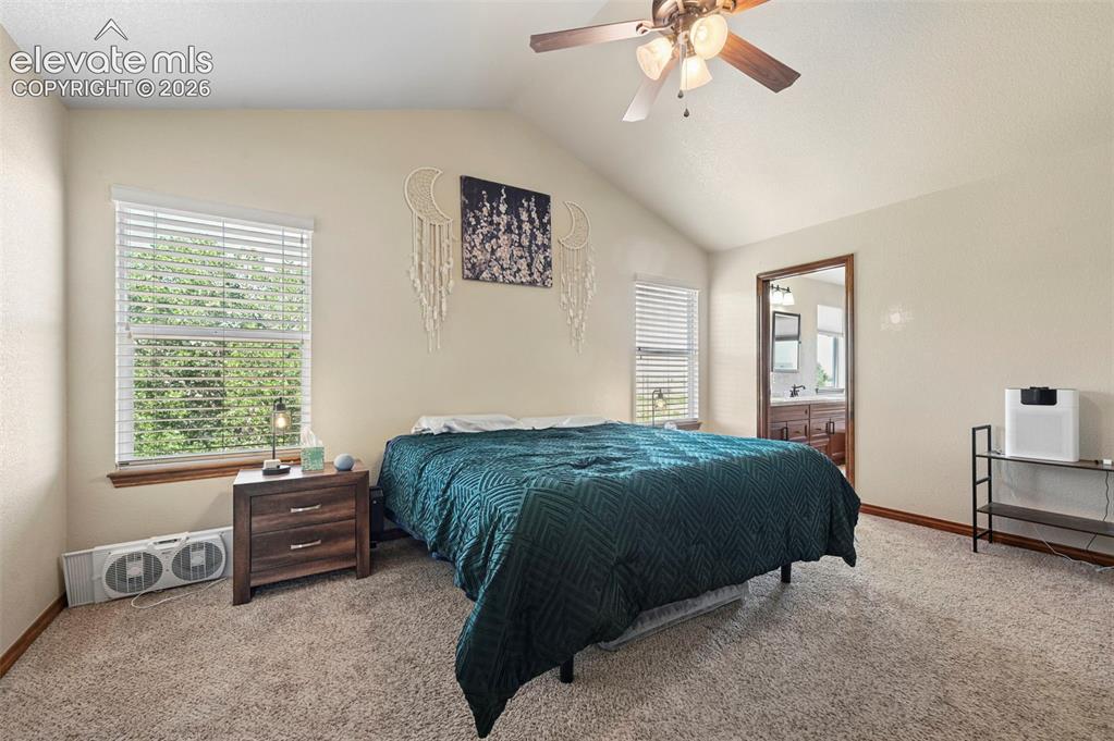 Image 7 of 34: Vaulted ceiling bedroom featuring carpeting, a ceiling fan with integrated