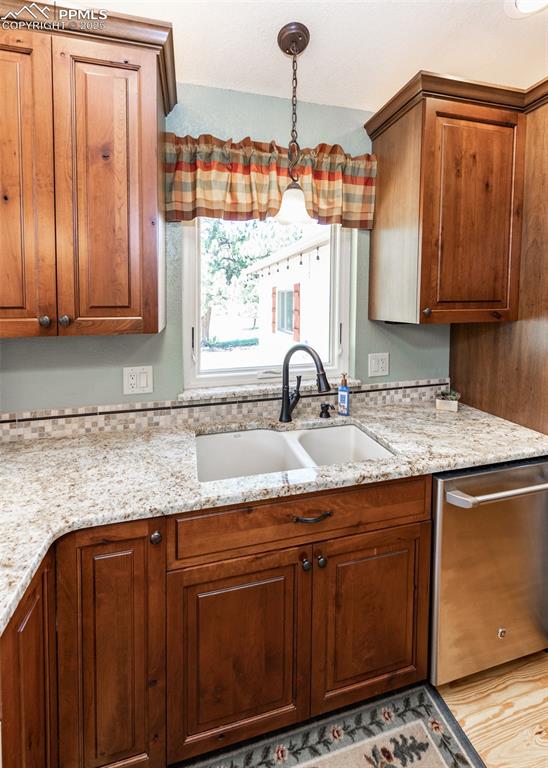 Image 17 of 48: Granite countertops with stylized tile backsplash. Enjoy the outdoors while