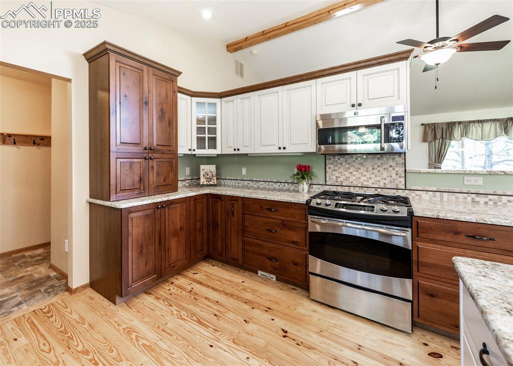 Image 19 of 48: Another view of the kitchen and the hallway from the garage and into the la