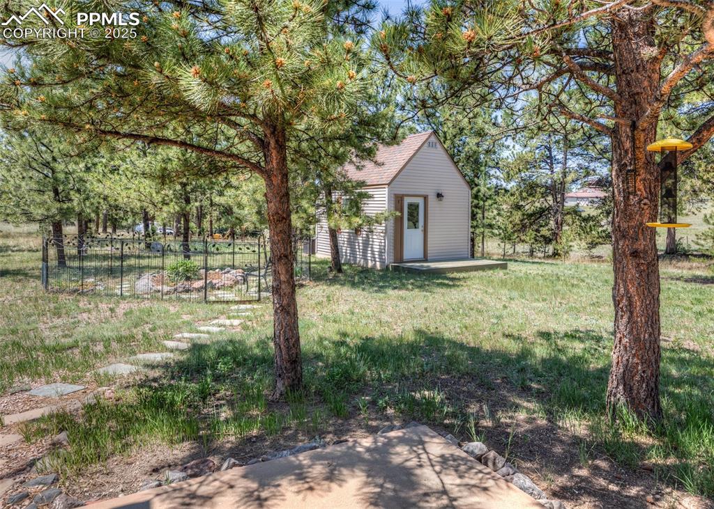Image 40 of 48: Craft/guest cottage nestled in the woods.