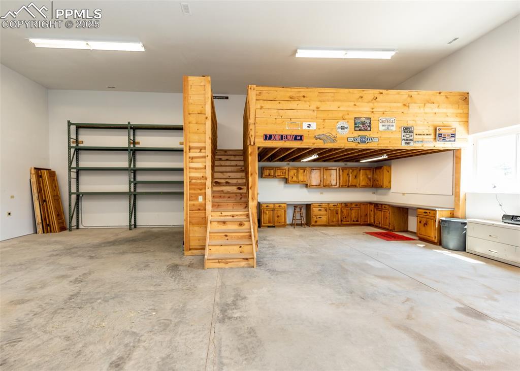 Image 7 of 48: Shelving and a loft above the workshop.