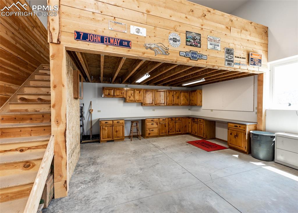 Image 8 of 48: Another view of all the storage/cabinetry and countertop space the workshop