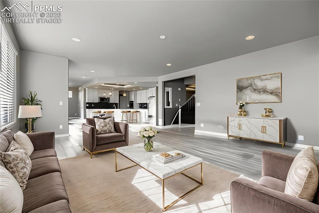 Image 16 of 35: Virtually staged main level living room featuring a fireplace, light wood-s