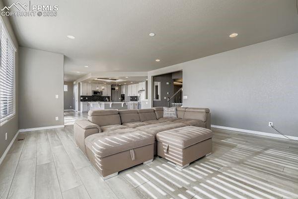 Image 17 of 35: Living room featuring light wood-style floors and recessed lighting