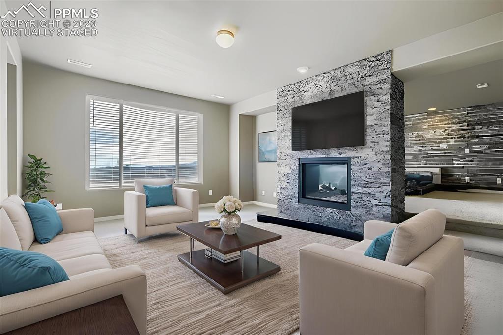 Image 19 of 35: Virtually staged primary bedroom retreat featuring a premium fireplace and 