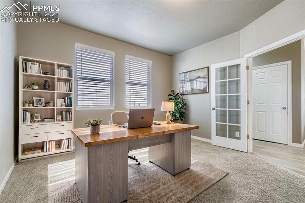Image 5 of 35: Virtually staged office featuring light carpet and baseboards