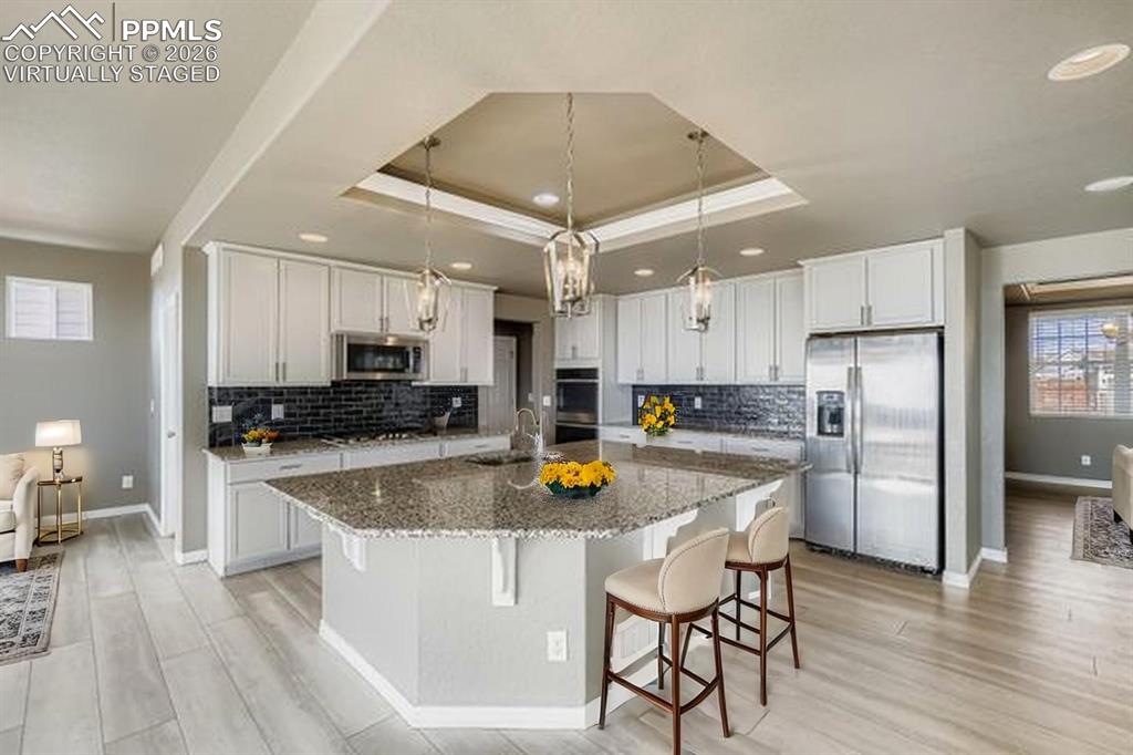 Image 9 of 35: Virtually staged kitchen featuring stainless steel appliances, light wood-t