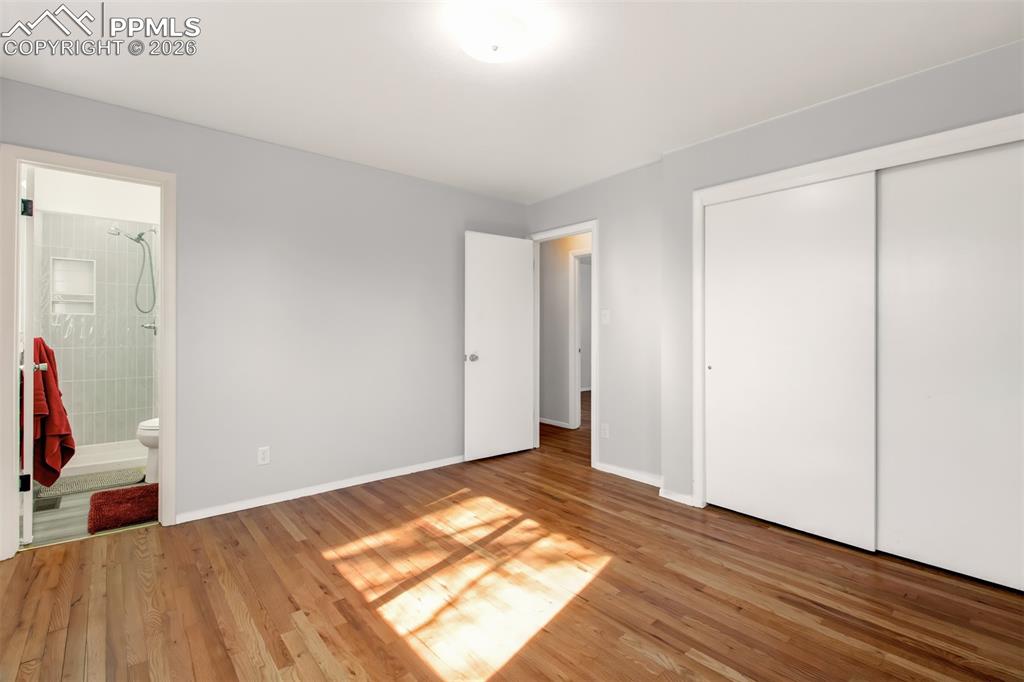 Image 20 of 35: primary bedroom with attached 3/4 bath