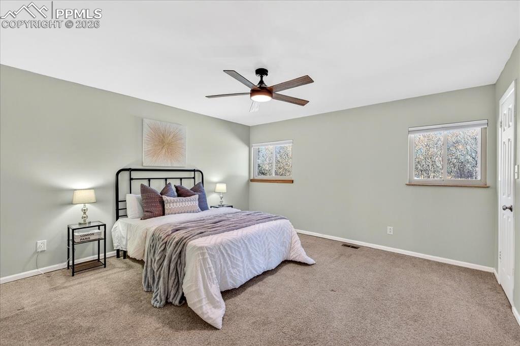 Image 25 of 49: Carpeted bedroom featuring baseboards and a ceiling fan