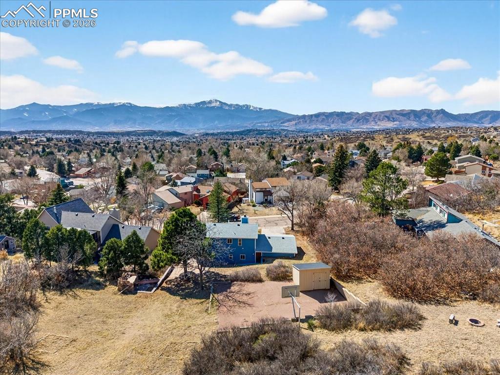 Image 4 of 49: Aerial perspective of suburban area with a mountain backdrop