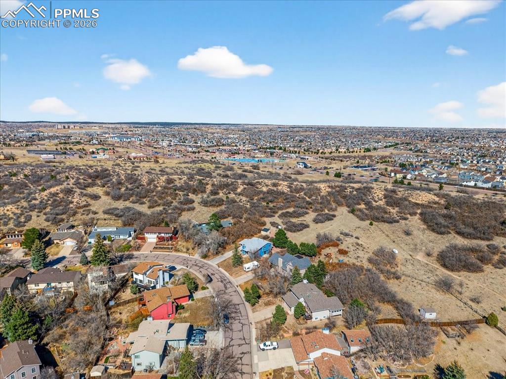 Image 42 of 49: Aerial view of residential area with a desert landscape