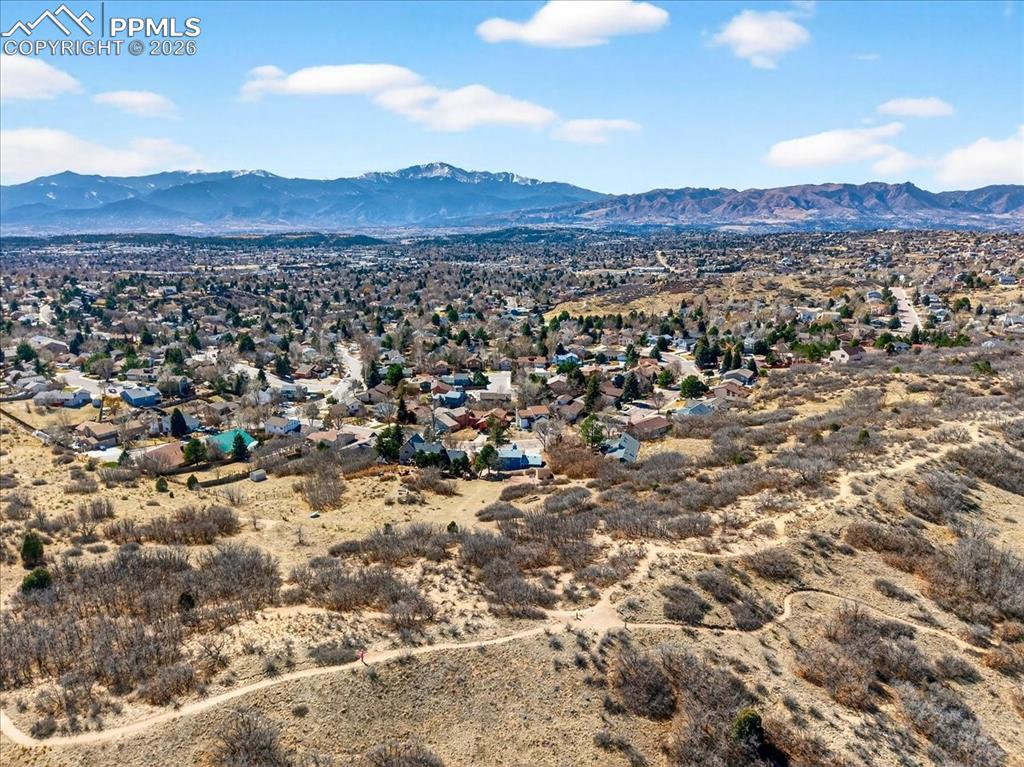 Image 43 of 49: Drone / aerial view of a mountainous background and a desert landscape